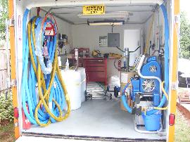 Graco H25 spray foam proportioner with heated hose installed in mobile spray rig.
